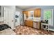 Well-lit kitchen with stainless steel appliances, wooden cabinets, and stylish flooring at 5640 Rolling Oaks Dr, Cumming, GA 30040