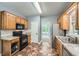 Modern kitchen with ample cabinet space, stainless appliances, tile backsplash, and stylish flooring at 5640 Rolling Oaks Dr, Cumming, GA 30040