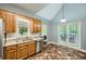 Bright kitchen featuring stainless steel appliances, wooden cabinets, and access to the outdoor area at 5640 Rolling Oaks Dr, Cumming, GA 30040