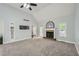 Spacious living room with high ceilings, a fireplace, carpet, and plenty of natural light at 5640 Rolling Oaks Dr, Cumming, GA 30040