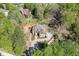 An aerial view showing the home's lush surrounding landscape and long driveway at 6050 Eagle Close Ln, Sugar Hill, GA 30518