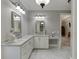 Bathroom with marble counters, double sinks, and adjoining bedroom view at 6050 Eagle Close Ln, Sugar Hill, GA 30518