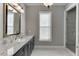 Bathroom featuring a large mirror, granite counters, and a glass shower at 6050 Eagle Close Ln, Sugar Hill, GA 30518