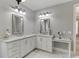 Bathroom with white marble counters, double sinks, and vanity at 6050 Eagle Close Ln, Sugar Hill, GA 30518