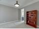 Neutral bedroom featuring a light fixture, plush carpet, and a rustic bookshelf at 6050 Eagle Close Ln, Sugar Hill, GA 30518