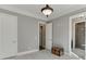Bedroom featuring hardwood floors, two doors, and ensuite bathroom at 6050 Eagle Close Ln, Sugar Hill, GA 30518