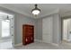 Gray bedroom with an interesting light fixture, plush carpet, and a rustic bookshelf at 6050 Eagle Close Ln, Sugar Hill, GA 30518