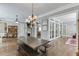 Open dining room with long wood table, stone fireplace and plenty of natural light at 6050 Eagle Close Ln, Sugar Hill, GA 30518
