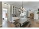 Open dining room with long wood table, white cabinets and view of kitchen at 6050 Eagle Close Ln, Sugar Hill, GA 30518
