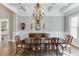 Bright dining room boasts coffered ceilings, a chandelier, a sideboard, and seating for six at 6050 Eagle Close Ln, Sugar Hill, GA 30518