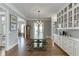 Bright dining room with dark wood table, white cabinets and plenty of natural light at 6050 Eagle Close Ln, Sugar Hill, GA 30518