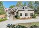 Charming brick home featuring meticulous landscaping and an inviting stone staircase leading to the front entrance at 6050 Eagle Close Ln, Sugar Hill, GA 30518
