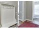 Hallway with coat rack and view into bathroom at 6050 Eagle Close Ln, Sugar Hill, GA 30518