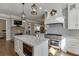 Open-concept kitchen with a center island, modern appliances, and seamlessly connects to the living area at 6050 Eagle Close Ln, Sugar Hill, GA 30518