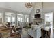 Cozy living room with high ceilings, hardwood floors, fireplace, a chandelier, and a comfortable seating area at 6050 Eagle Close Ln, Sugar Hill, GA 30518