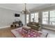 Comfortable bonus room featuring natural light, a cozy seating area, and hardwood flooring at 6050 Eagle Close Ln, Sugar Hill, GA 30518