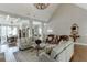 Bright and airy living room featuring hardwood floors, coffered ceilings, and elegant furnishings and a large chandelier at 6050 Eagle Close Ln, Sugar Hill, GA 30518