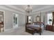 View of the primary bedroom, with four poster bed and an ensuite bathroom at 6050 Eagle Close Ln, Sugar Hill, GA 30518
