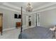 Primary bedroom with a four poster bed, neutral carpet, and plenty of space at 6050 Eagle Close Ln, Sugar Hill, GA 30518