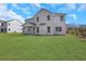 Expansive backyard features lush green lawn and provides ample space for outdoor activities and relaxation at 6680 Benchwood Path, Cumming, GA 30028