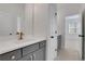 Bright bathroom with white countertop, modern gray cabinets, and gold hardware at 6680 Benchwood Path, Cumming, GA 30028