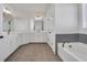 A luxurious bathroom with double vanity, soaking tub, and separate shower at 6680 Benchwood Path, Cumming, GA 30028