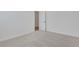 Bedroom features plush carpet, bright white walls, and a glimpse of wood flooring through the doorway at 6680 Benchwood Path, Cumming, GA 30028