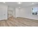Bedroom with light wood floors, recessed lights, and bright white walls with trim at 6680 Benchwood Path, Cumming, GA 30028