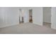 Neutral bedroom with doorways to an ensuite bathroom and closet space at 6680 Benchwood Path, Cumming, GA 30028