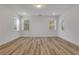 Spacious bedroom featuring a light-colored wood floor and bright white walls and trim at 6680 Benchwood Path, Cumming, GA 30028