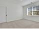 Cozy bedroom with neutral carpet, bright white walls, and a window with horizontal blinds at 6680 Benchwood Path, Cumming, GA 30028