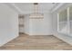 Dining area showcasing wood-look floors and white trim and moulding at 6680 Benchwood Path, Cumming, GA 30028