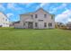 Well maintained backyard with an exterior view of a white two story home at 6680 Benchwood Path, Cumming, GA 30028