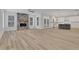 Open-concept living room features a stone fireplace and neutral flooring at 6680 Benchwood Path, Cumming, GA 30028