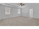 Spacious main bedroom with neutral carpet and bright white walls and trim at 6680 Benchwood Path, Cumming, GA 30028