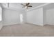 A bright main bedroom features a tray ceiling and large window for natural light at 6680 Benchwood Path, Cumming, GA 30028