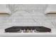 Close up of a stainless steel Frigidaire gas cooktop, set in white stone countertop at 6680 Benchwood Path, Cumming, GA 30028