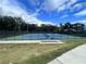 Outdoor community tennis courts with blue and green surface, surrounded by tall trees and a fence at 6680 Benchwood Path, Cumming, GA 30028