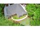 Aerial view of a home with a walkway, lush lawn, surrounded by green trees, and a white car parked in the driveway at 7675 Lanier View Rdg, Cumming, GA 30041