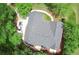 Aerial view of a house featuring a gray roof, surrounded by lush greenery at 7675 Lanier View Rdg, Cumming, GA 30041