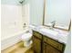 Bright bathroom featuring a tub-shower combo and a modern vanity with granite countertop at 7675 Lanier View Rdg, Cumming, GA 30041