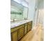 Bathroom featuring dual sinks with granite countertop and wood cabinets at 7675 Lanier View Rdg, Cumming, GA 30041