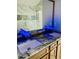 Bathroom featuring a marble-look countertop, modern faucet, and frameless glass shower at 7675 Lanier View Rdg, Cumming, GA 30041