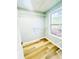 Walk-in closet with wire shelving, wood-look floors and a sun-filled window overlooking the greenery at 7675 Lanier View Rdg, Cumming, GA 30041