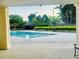 Community pool with lounging chairs and manicured landscaping with trees at 7675 Lanier View Rdg, Cumming, GA 30041