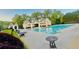 Large community pool with lounge chairs and tables on the pool deck at 7675 Lanier View Rdg, Cumming, GA 30041