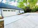 Extended concrete driveway offering lots of parking and leading to a two-car garage at 7675 Lanier View Rdg, Cumming, GA 30041