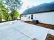 Long concrete driveway leading to a two-car garage with well landscaped surroundings at 7675 Lanier View Rdg, Cumming, GA 30041