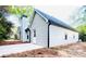 Exterior showcasing the siding, door, and chimney, complemented by a new driveway at 7675 Lanier View Rdg, Cumming, GA 30041