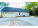 Spacious garage with a large concrete driveway and convenient access to the home's side entrance at 7675 Lanier View Rdg, Cumming, GA 30041